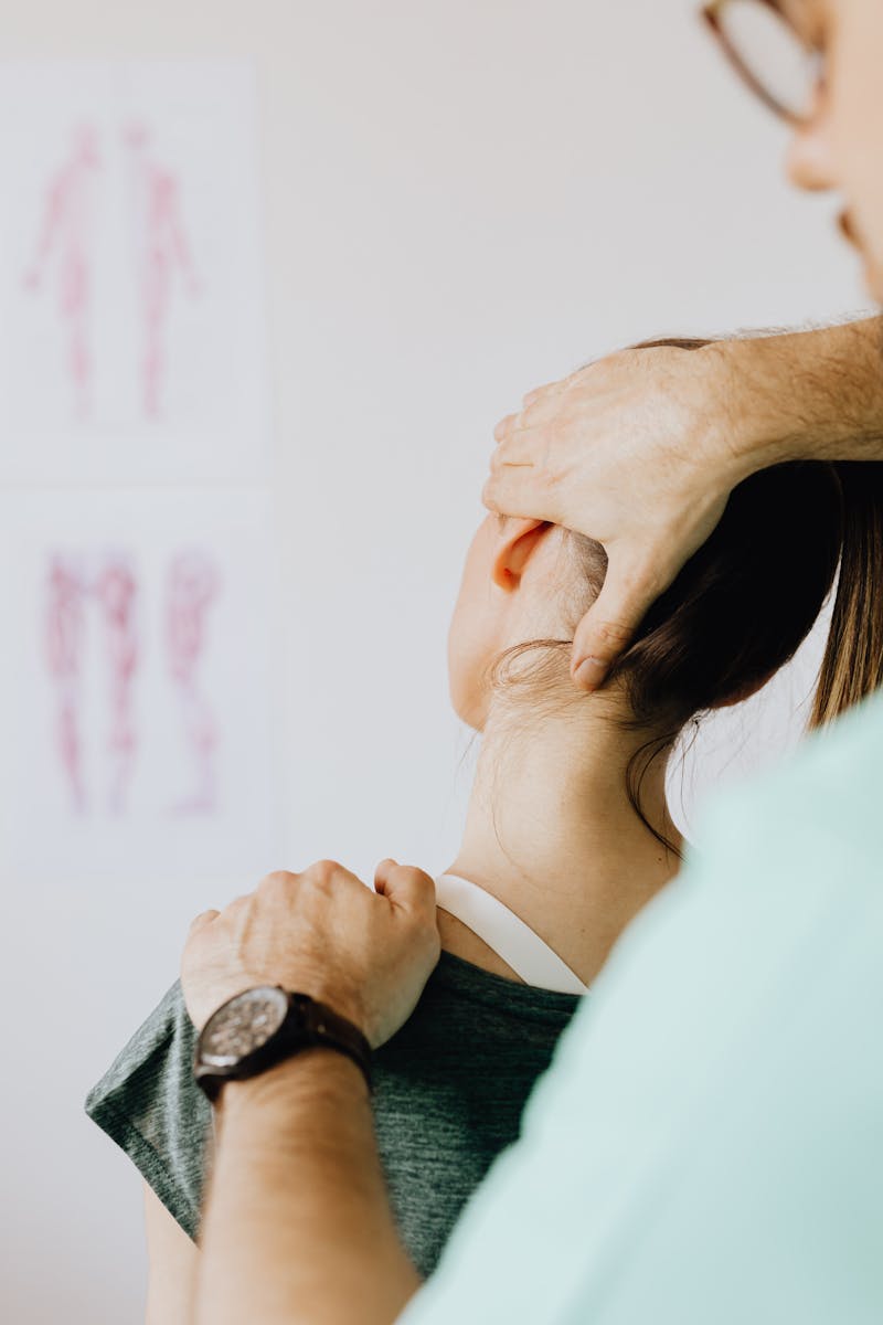 Czym jest fizjoterapia i jak może zmienić twoje życie? A female patient receives a chiropractic neck adjustment in a medical office for pain relief.